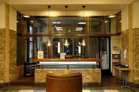 a lobby with a checkered floor and a large window.